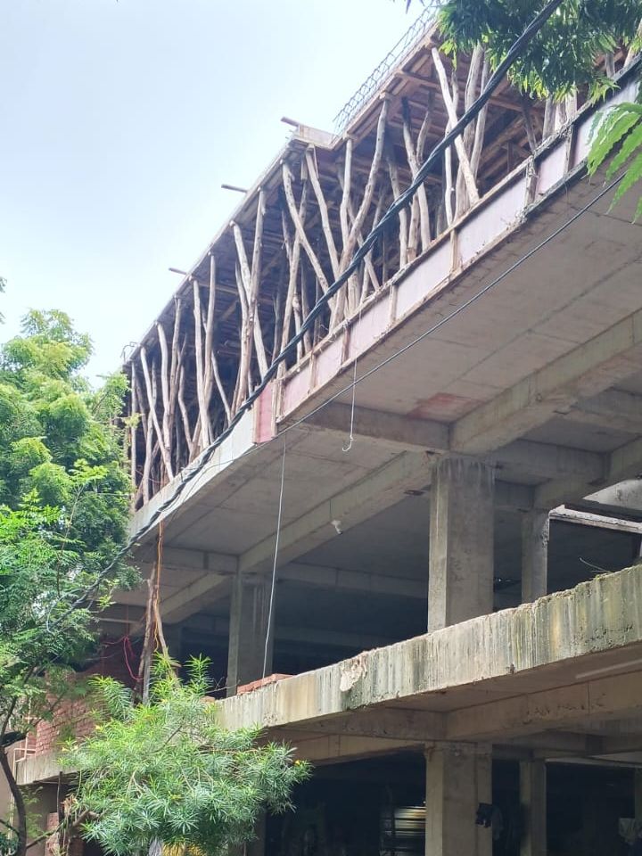 The first-floor roof slab, cast, with timber shuttering for the second floor above it